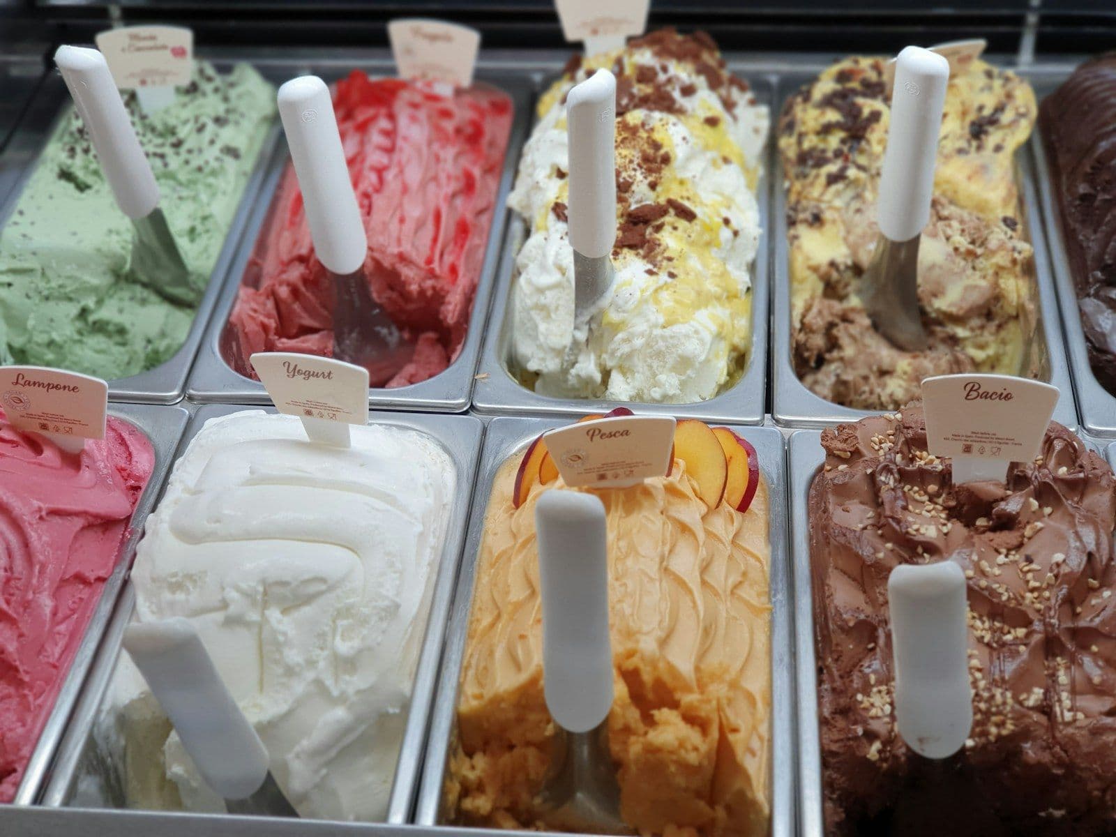 Trays of gelato flavors in a display case
